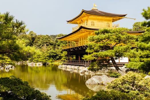 The world famous Kinkakuji Temple (The Golden Pavilion) in Kyoto, Japan on a warm autumn morning