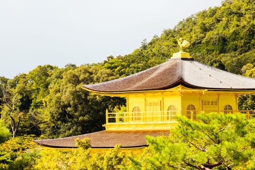 The world famous Kinkakuji Temple (The Golden Pavilion) in Kyoto, Japan on a warm autumn morning
