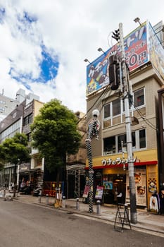 OSAKA, JAPAN - SEPTEMBER 26 2024: The trendy and fashionable Amerikamura district on a clear autumn day in Osaka, Japan