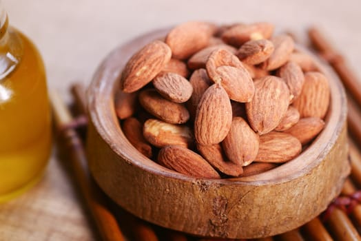almond oils and fresh nuts on table ,
