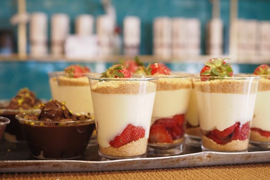 Delightful dessert cups with rich cream, fresh strawberries, and a crunchy crumb topping