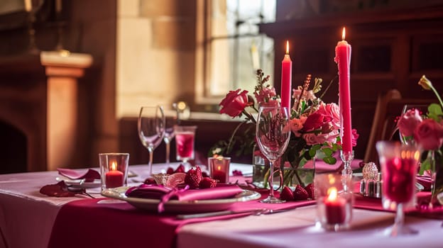 Festive table setting with candles and arrangement of beautiful red flowers. Holiday concept. High quality photo