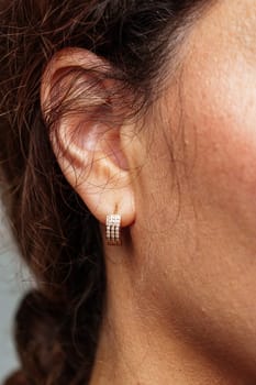 Close-up view of a woman wearing elegant diamond earrings