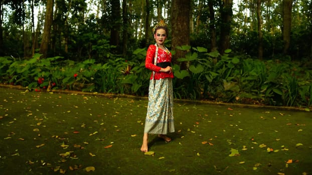a traditional dancer called ronggeng stands with an expression full of beauty and beauty in a magical forest in the afternoon
