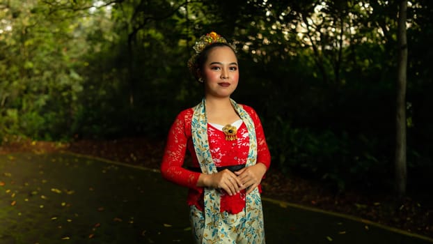 Traditional Javanese dancers wear red costumes that are full of details and ornaments depicting natural elements and symbols of Sundanese beliefs in the costumes
