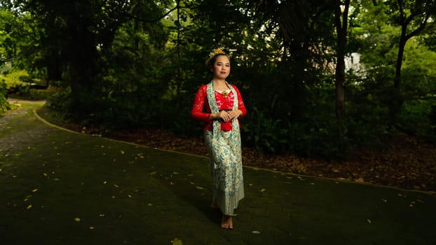 Traditional Javanese dancers wear red costumes that are full of details and ornaments depicting natural elements and symbols of Sundanese beliefs in the costumes