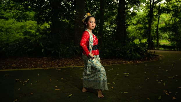 Traditional Javanese dancers wear red costumes that are full of details and ornaments depicting natural elements and symbols of Sundanese beliefs in the costumes