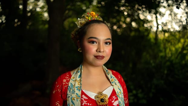 Traditional Javanese dancers wear red costumes that are full of details and ornaments depicting natural elements and symbols of Sundanese beliefs in the costumes
