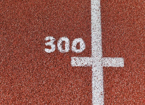 Three hundred meter mark on a running track at a stadium