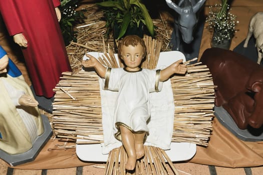 Baby Jesus laying in a cradle Christmas Creche