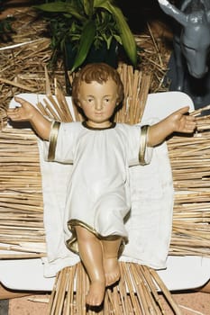 Baby Jesus laying in a cradle Christmas Creche