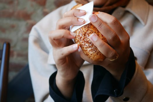A detailed closeup shot of hands holding a wonderfully delicious pastry with care and delicacy