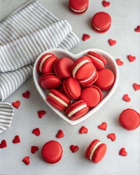 Macarons cookies in heart shaped bowls, flat lay of red french macarons. Anniversary, Birthday, Valentine's day.