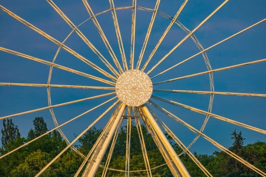 Center of ferris wheel with glowing dots in the middle at sunny afternoon