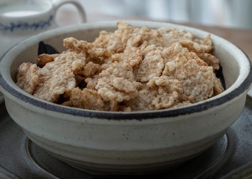 Tasty Cereal in Ceramic bowl served with Milk for Healthy breakfast. Space for text, Selective focus.