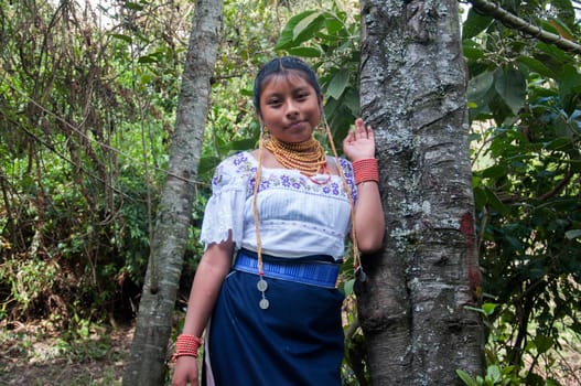 In the Heart of the Jungle: Indigenous Beauty in a Tree-side Pose. High quality photo