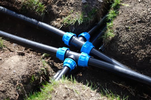 Closeup of plastic pipes of plant watering system in gardens. Gardening plant care concept