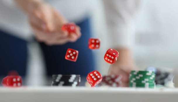 Five red dice are discarded from hand. Gambling and roulette concept