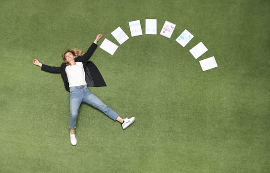 Woman is lying on green lawn along with chart business analytics. Advertising business banner place for text