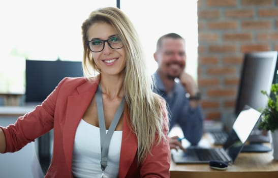 Portrait of happy businesswoman in glasses at workplace in office. Smiling confident young woman manager