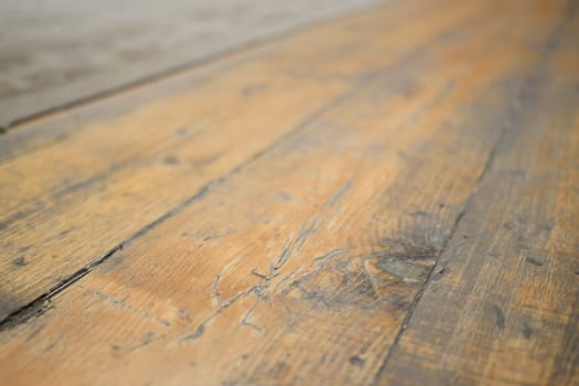 A close view of worn wooden flooring showcasing its rich and intricate textures