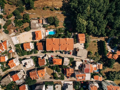Swimming pools among green trees in the courtyards of apartment buildings. Drone. High quality photo