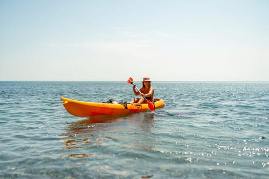 Kayak sea woman. Happy attractive woman with long hair in red swimsuit, swimming on kayak. Summer holiday vacation and travel concept
