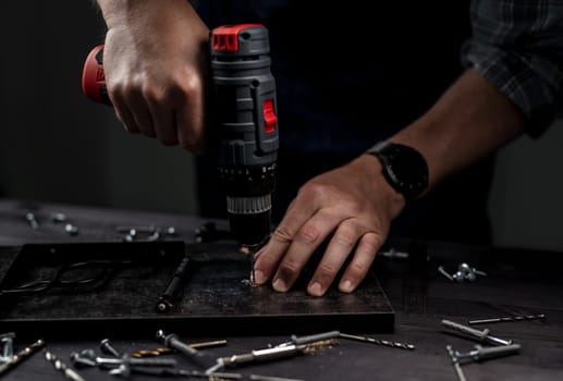 Master Drills Hole With Drill In Hands Close Up