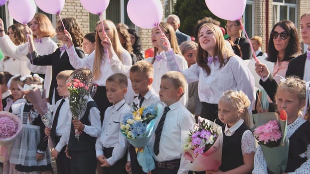 Schoolchildren on the day of knowledge with balloons