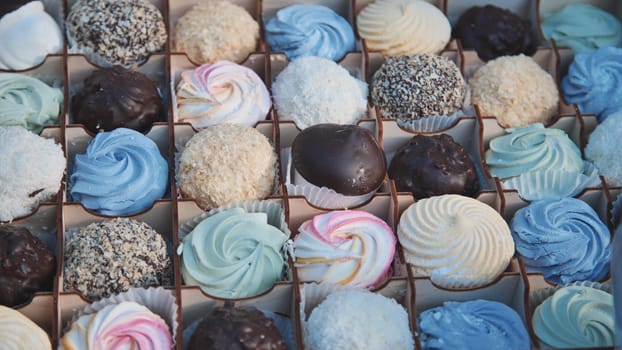Delicious assorted marshmallows and chocolate candies arranged beautifully in a gift box, creating a tempting display of sweetness
