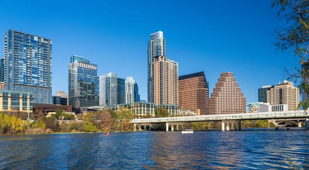 Modern apartment buildings and offices by the Colorado River in cityscape skyline of Austin Texas from the Town Park