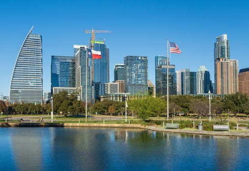 Modern apartment buildings and offices by the Colorado River in cityscape skyline of Austin Texas across Palmer Lake in December