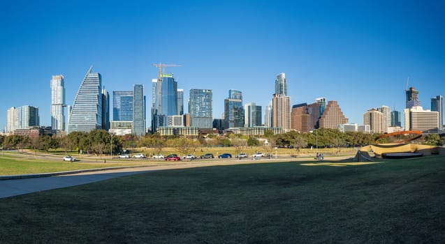 Modern apartment buildings and offices by the Colorado River in cityscape skyline of Austin Texas from the Town Park