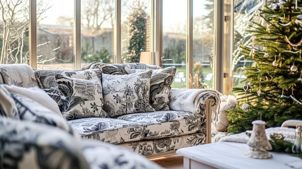 Colorful pillows on sofa against glass wall of window in a winter garden or conservatory. Interior textile concept. High quality photo