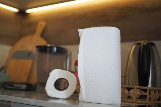 A contemporary kitchen scene with essential items like paper towels and a blender
