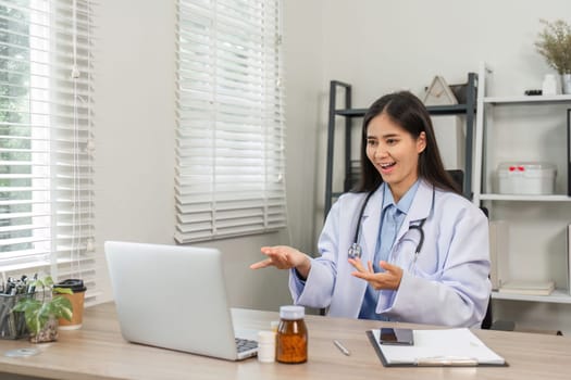 Confident female doctor conducting an online consultation in a modern office, showcasing professionalism and expertise.
