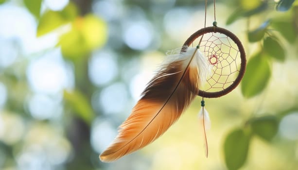 Dream catcher with feathers hanging on tree branch, creating a peaceful and spiritual atmosphere