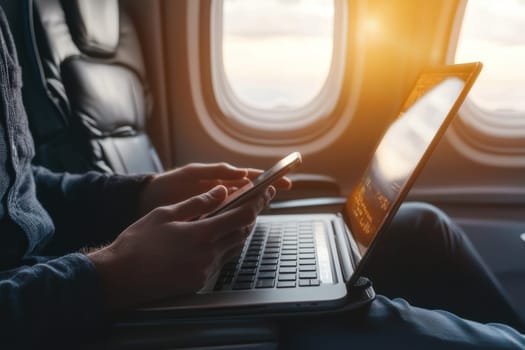 A businessman using smartphone and laptop while traveling on plane, enjoying productivity in air