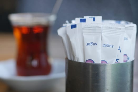 white sugar in a paper packet on table .