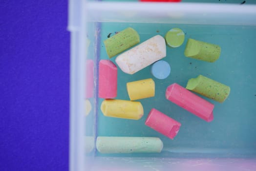 Vibrant chalk pieces submerged in water are perfect for art and educational activities