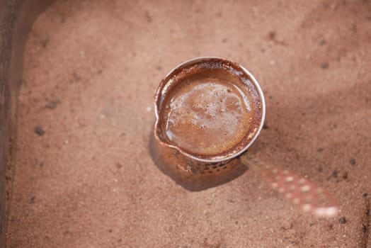 top view of making traditional turkish coffee on sand