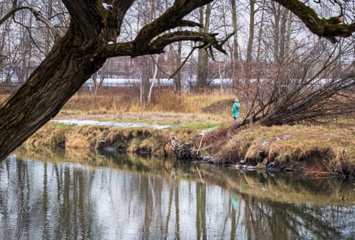 Shot of the woman fishing on the winter river
