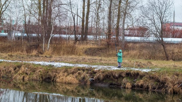 Shot of the woman fishing on the winter river