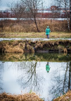 Shot of the woman fishing on the winter river