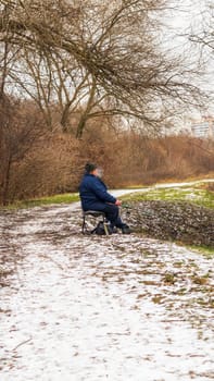 Shot of the man fishing on the winter river