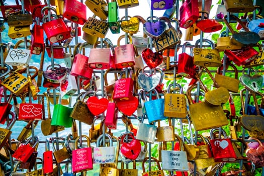 Hallstatt, Austria - 22 September 2018: A lot of colorful different shaped love locks on the fence