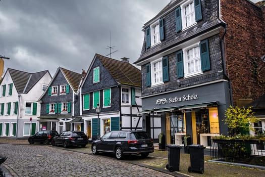 Solingen Geafrath, Germany - 2022 October 01: Paving Stones Road in the morning with Traditional Slate houses in Solingen Greafrath, Germany