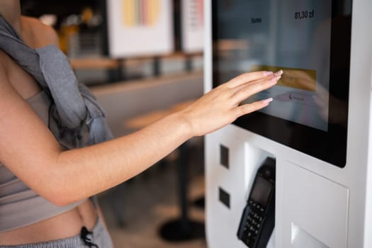 Poznan, Poland - 28 August 2024: Girl Using Mcdonald's Self-Service Screen For Food Order
