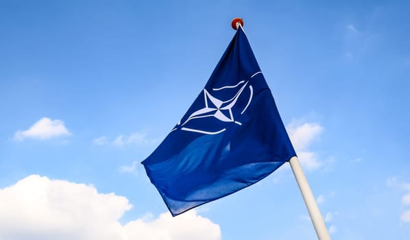Hague, Netherlands - 04 September 2023: NATO flag in Blue sky