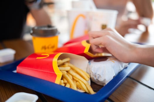 Poznan, Poland - 28 August 2024: Children Enjoying French Fries At A Mcdonald's Restaurant